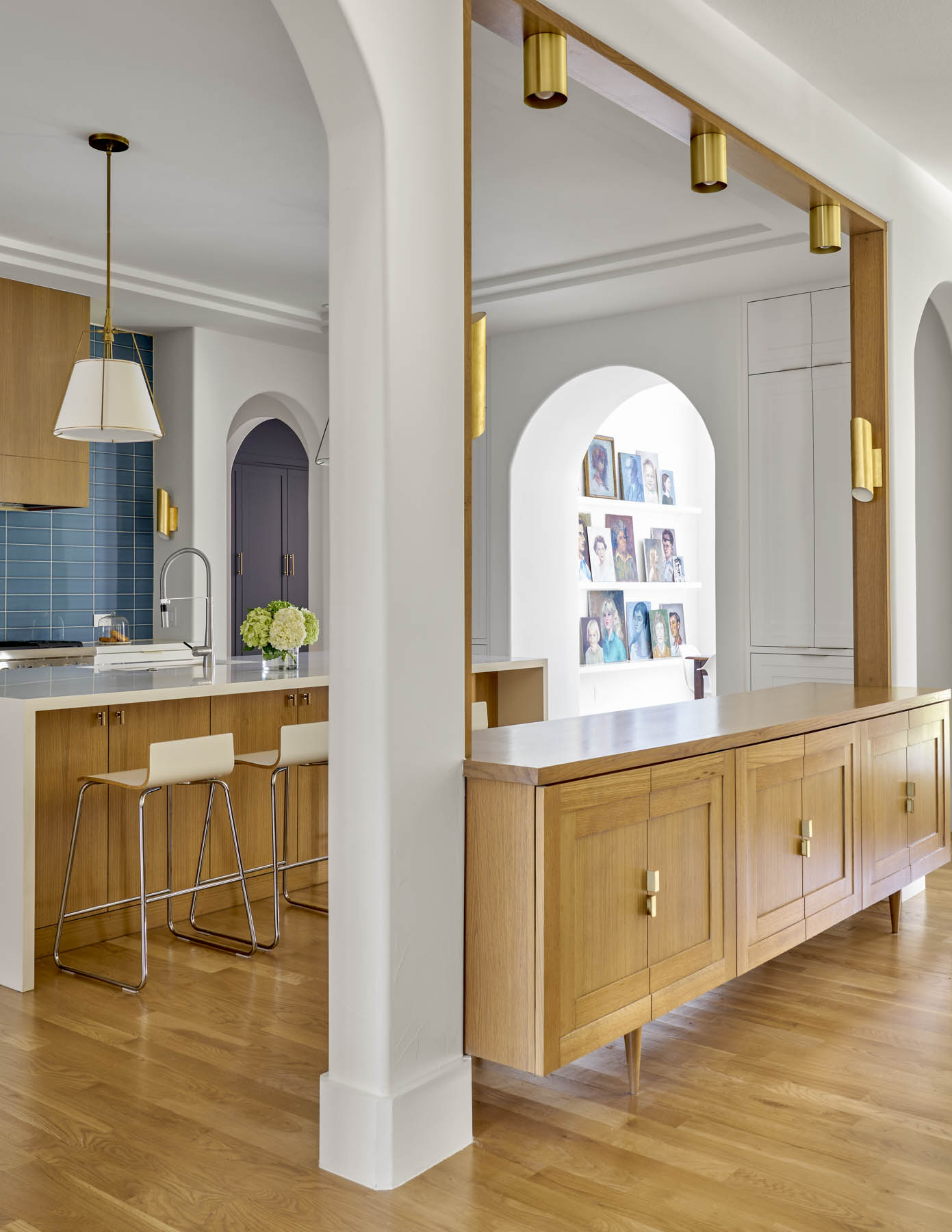 A kitchen and living room, with a column in the middle where there used to be a wall