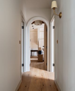 Long narrow landing leading to bedroom with wide long oak flooring