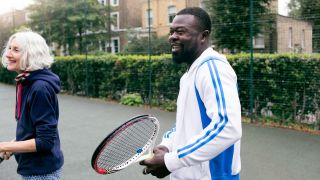 Casual tennis players holding rackets