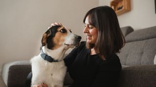 Woman petting dog — tips for training your dog