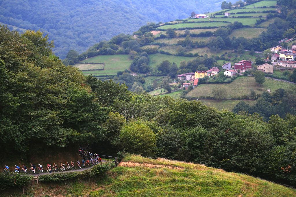 ALTU DEL GAMONITEIRU SPAIN SEPTEMBER 02 A general view of Primoz Roglic of Slovenia and Team Jumbo Visma red leader jersey and the peloton passes through Santullano landscape during the 76th Tour of Spain 2021 Stage 18 a 1626km stage from Salas to Altu dEl Gamoniteiru 1770m lavuelta LaVuelta21 on September 02 2021 in Altu dEl Gamoniteiru Spain Photo by Tim de WaeleGetty Images