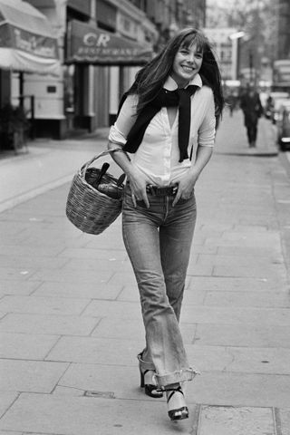 Jane Birkin walking through Paris holding a basket