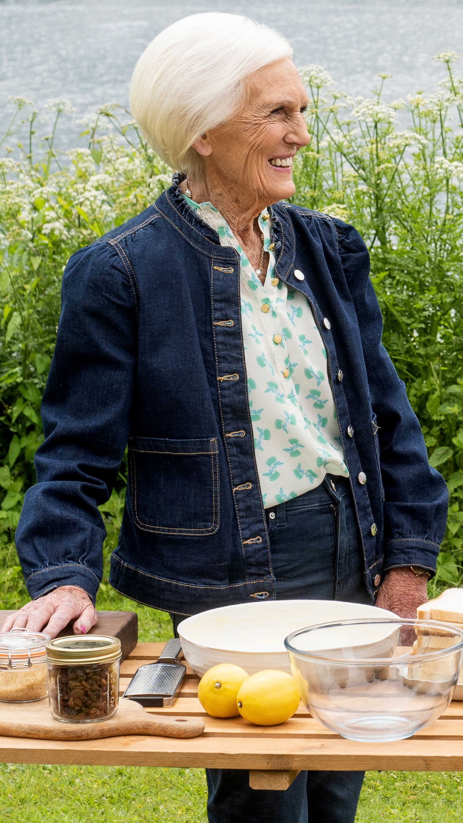Dame Mary Berry smiles in front of a table of ingredients in Mary at 90