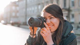 Woman taking a photograph with Sony A7 III camera