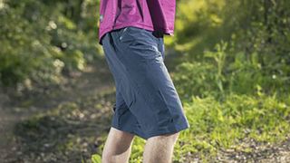 Man wearing Gore Fernflow shorts with grassy backdrop