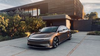 Lucid Air parked outside a modern hosue