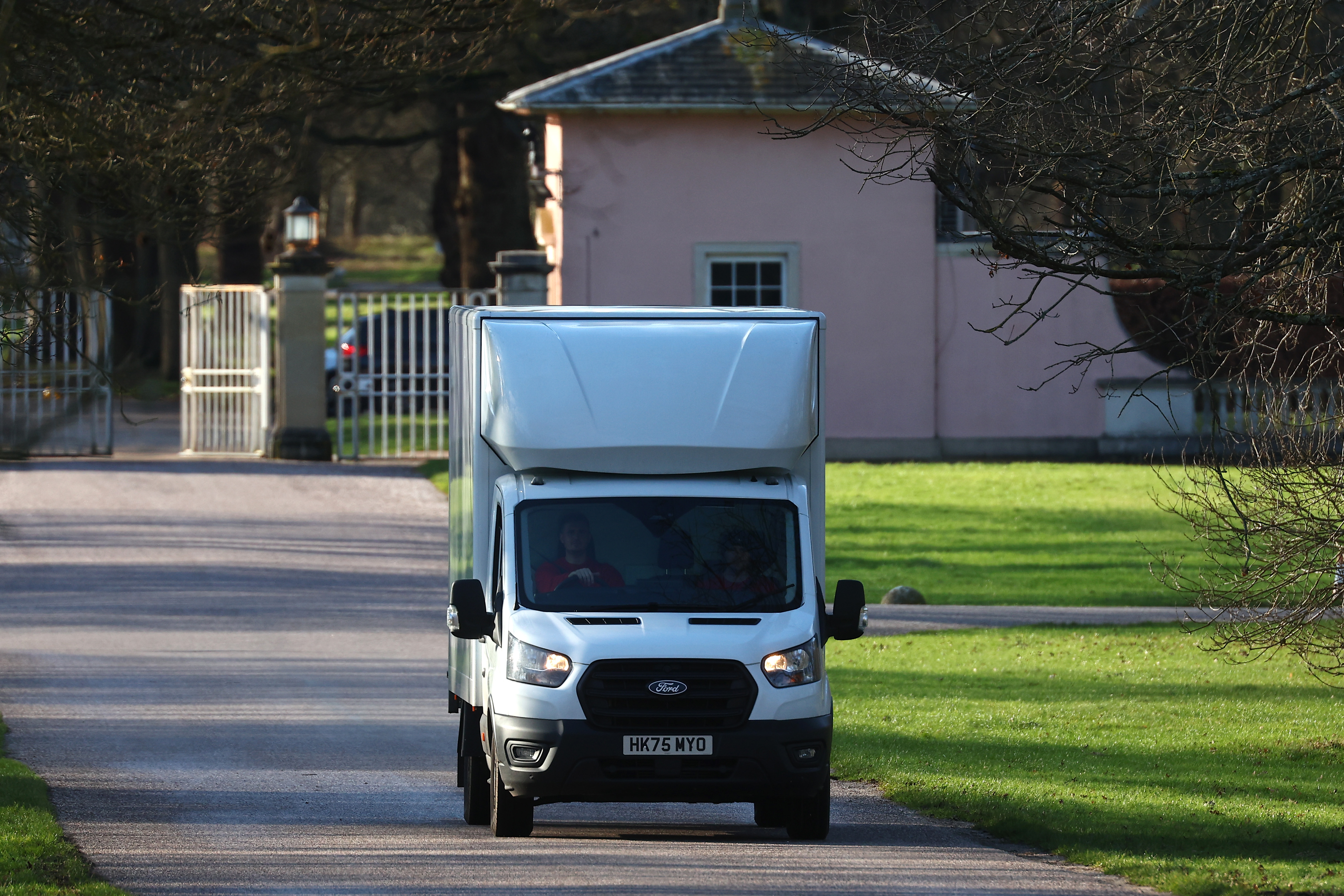 A moving van driving away from Royal Lodge