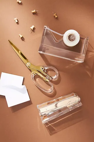 scissors on a desk with other items