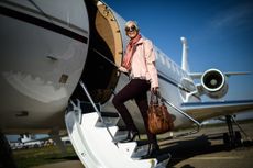 Woman boarding a private flight at the airport.