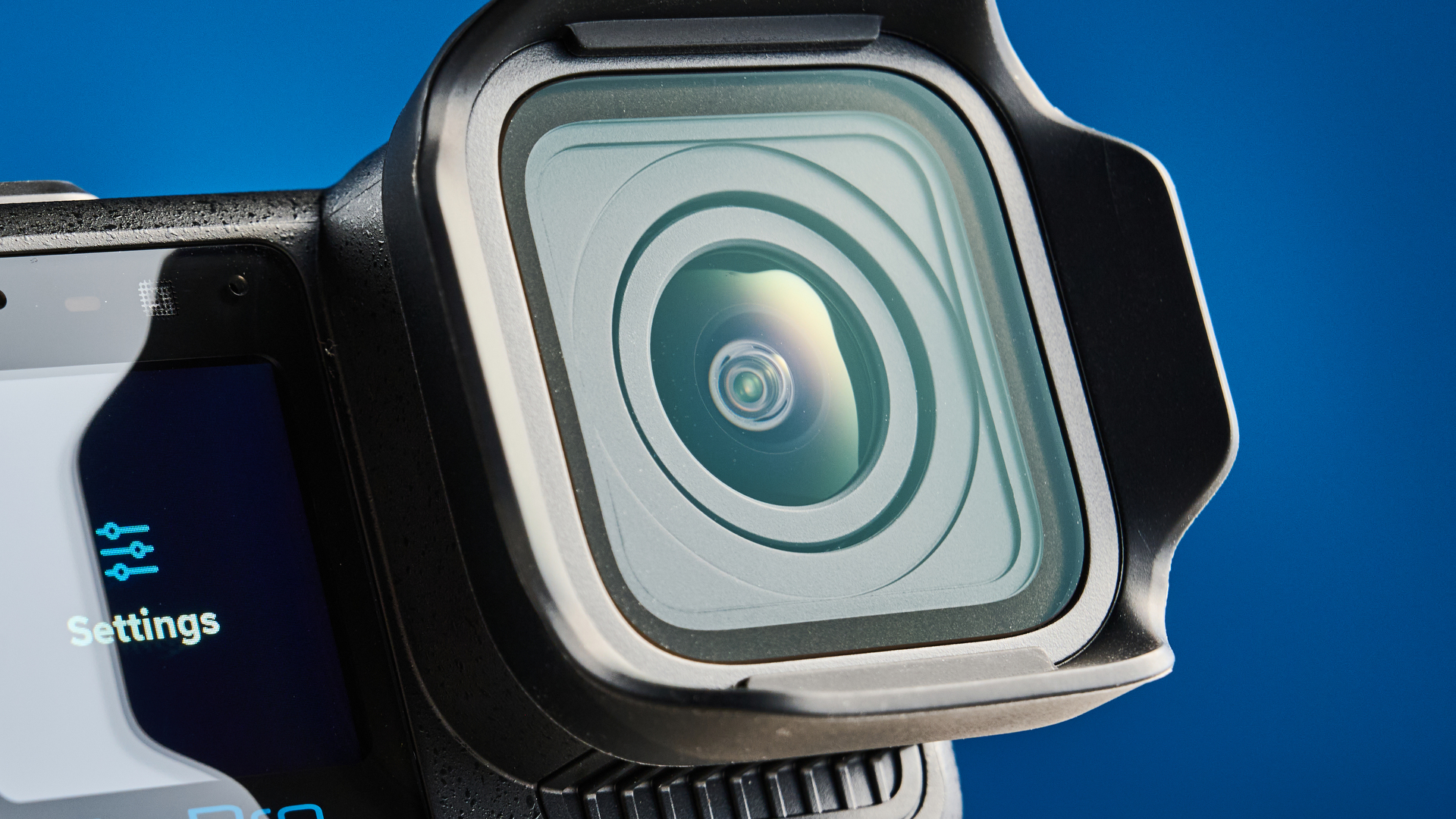 The GoPro Mission 1 Pro lens against a blue background