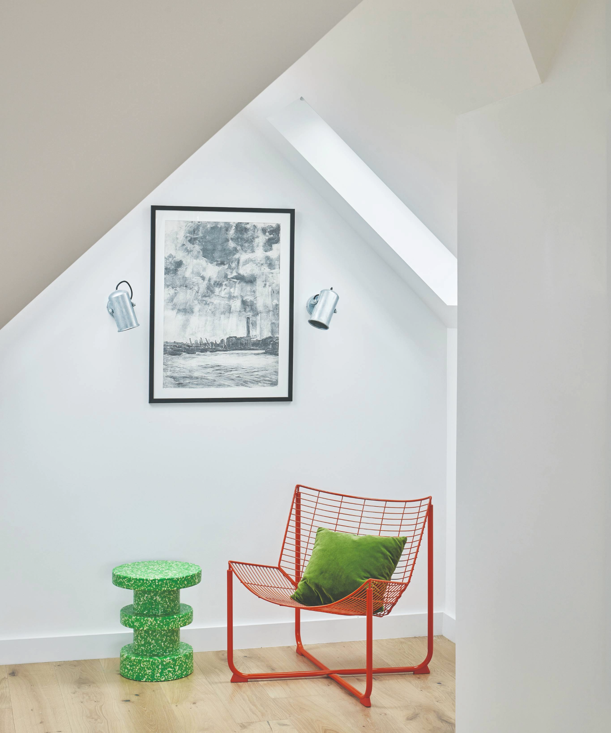 Red chair and green table in white hallway