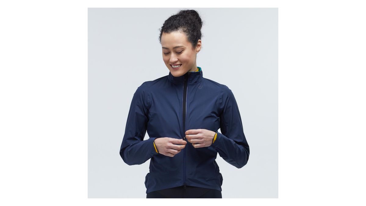 Woman wearing the Velocio Ultralight Rain Jacket