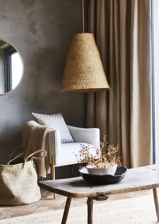 Rustic lounge with large natural ceiling pendant, and natural textures.