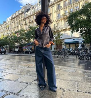 woman wearing leather blazer and baggy jeans with stiletto heels