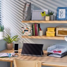 Aldi portable monitor set up on desk with shelves