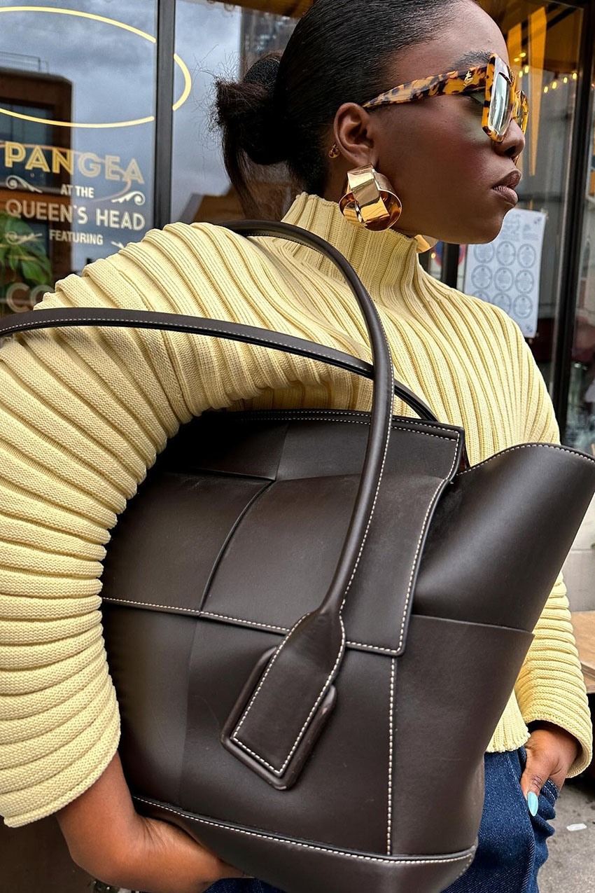 a women wearing bold gold earrings