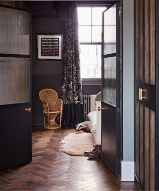 Wooden chair, black doors, wooden floor, badger