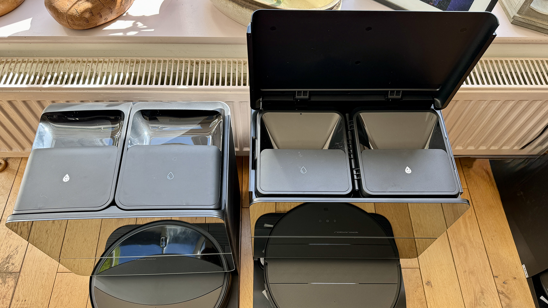 Docks for Roborock Saros 10R and Saros 10 robot vacuums, showing water tanks