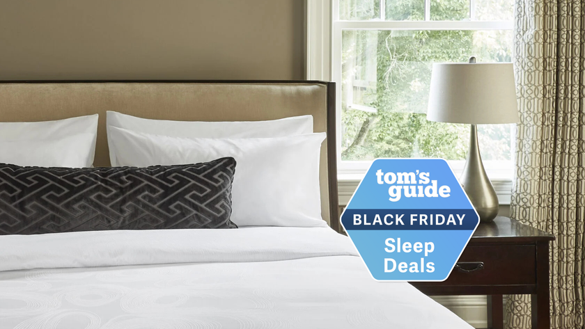 A luxurious hotel bedroom with plush pillows, duvets, a decorated throw pillow on the bed 