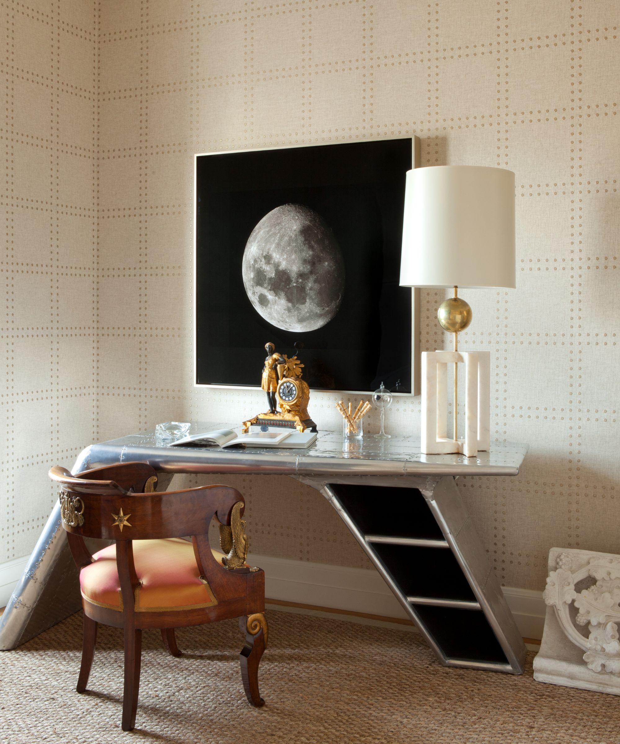 office with airplane wing desk and traditional chair with moon picture on wall