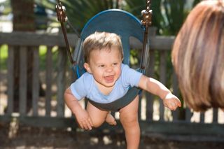 baby swinging at a playground