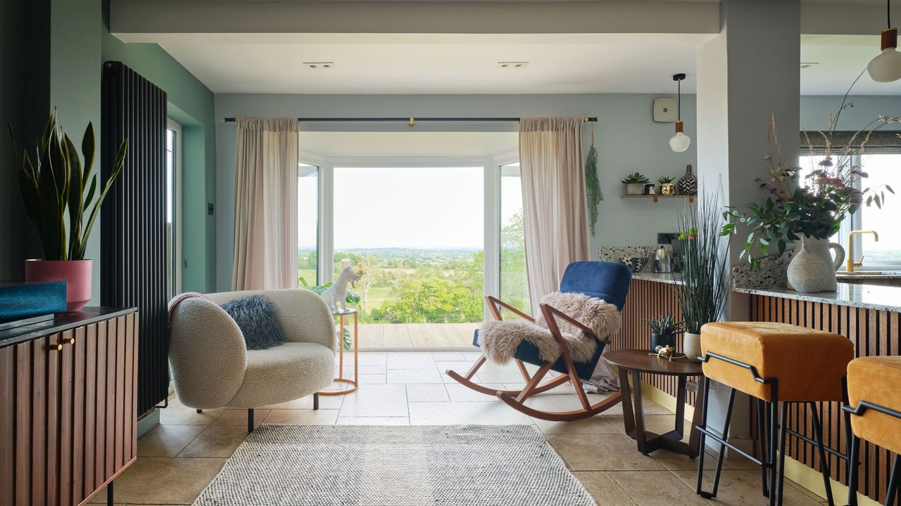 Living area with boucle chair, rocking chair and picture window