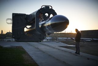 An Electron rocket being set up on the launchpad at the Rocket Lab launch facility in New Zealand, ahead of the