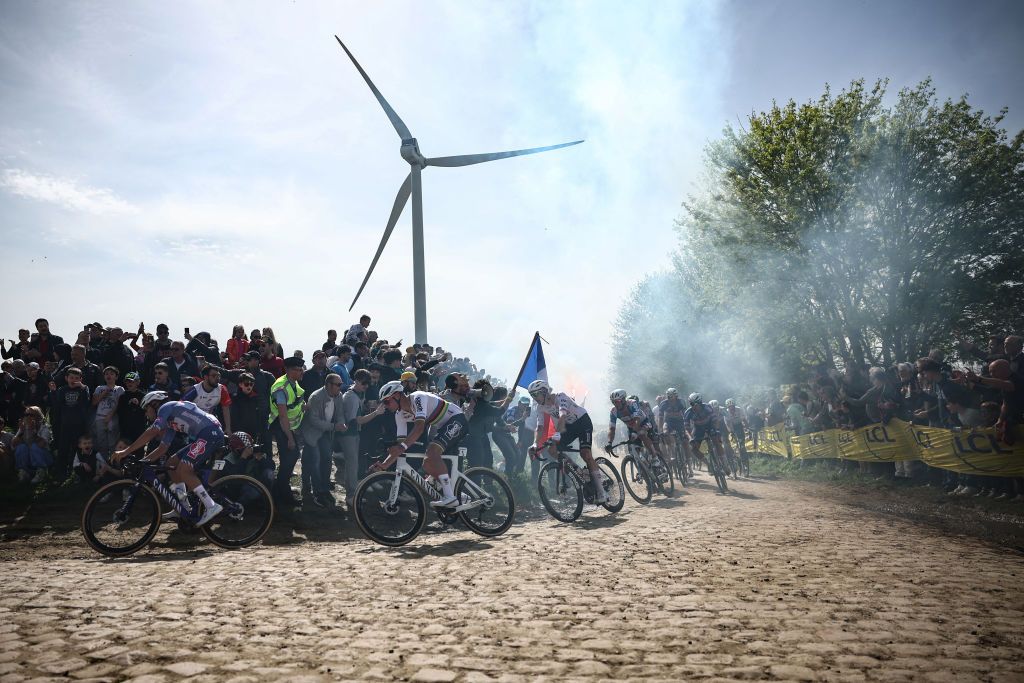 Alpecin - Deceuninck team's Dutch rider Mathieu Van Der Poel (2nd L) cycles with the pack of riders over the cobblestone sector 27 during the 121st edition of the Paris-Roubaix one-day classic cycling race, 260km between Compiegne and Roubaix, northern France, on April 7, 2024. (Photo by Anne-Christine POUJOULAT / AFP)