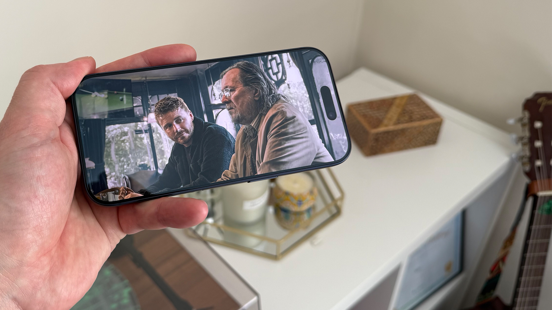 Apple iPhone 17 Pro smartphone held in hand, on screen is Slow Horses