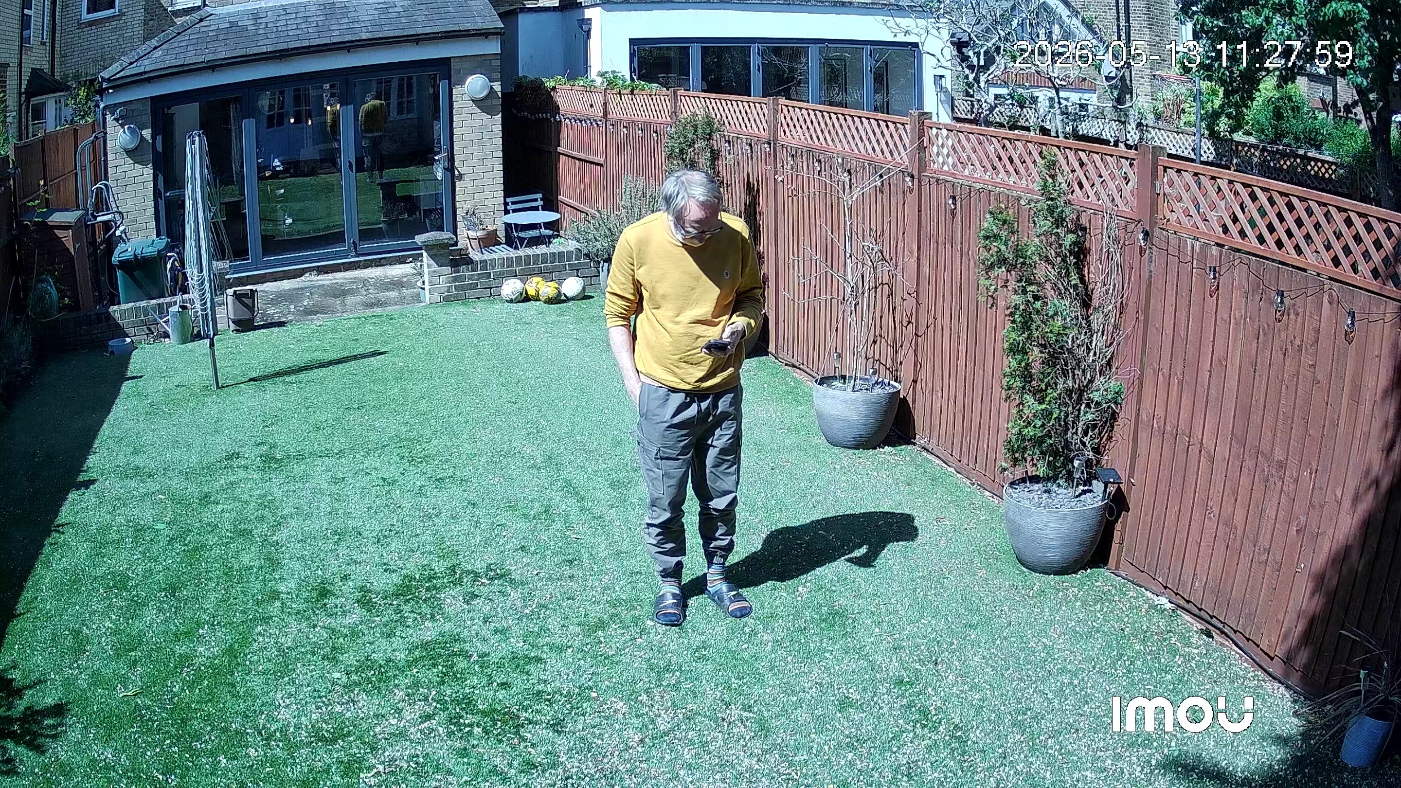Footage from IMOU AOV PT security camera showing man in garden