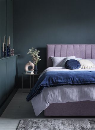 Teal bedroom walls with a lilac divan bed