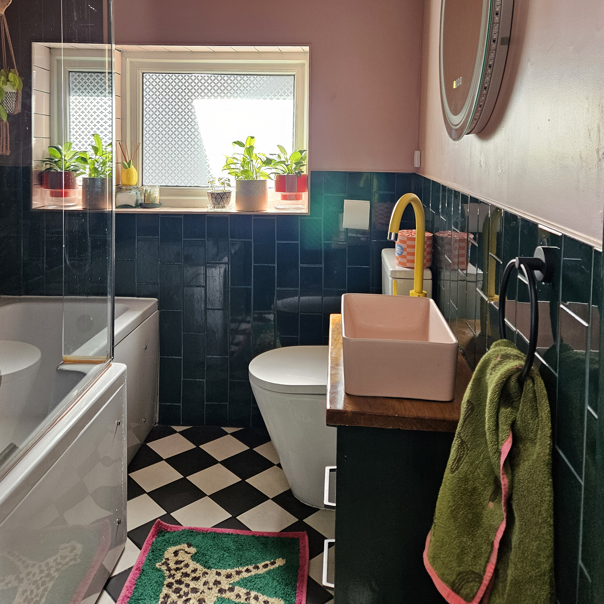pink bathroom with blue tiles and checkerboard floor