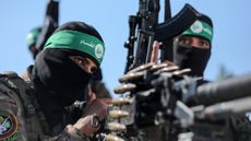 Hamas fighters take part in a military parade in June 2023
