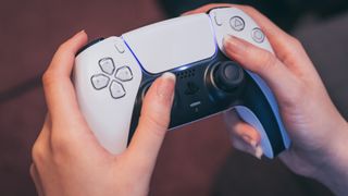 Woman holding a PS5 DualSense controller