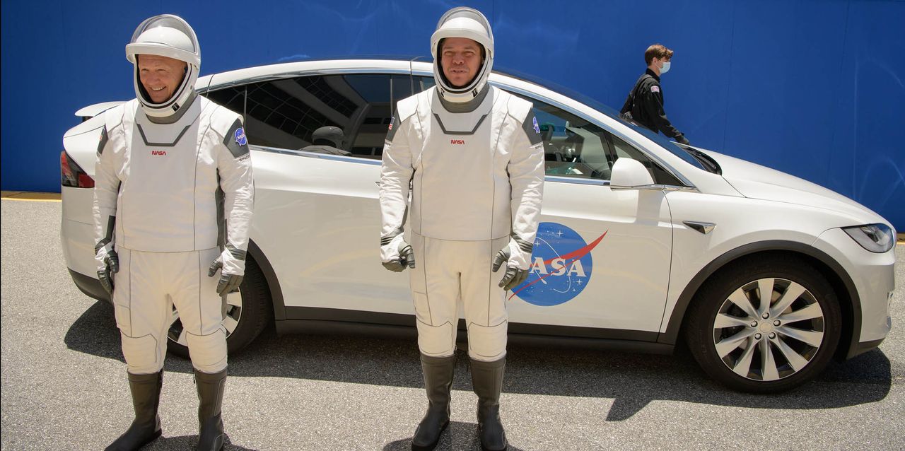 NASA astronauts Bob Behnken and Doug Hurley walk out of NASA's Astronaut Crew Quarters and take a Tesla Model X to Launch Pad 39A during a dry-run test of their SpaceX Crew Dragon Demo-2 flight on May 23, 2020 at the Kennedy Space Center in Florida.