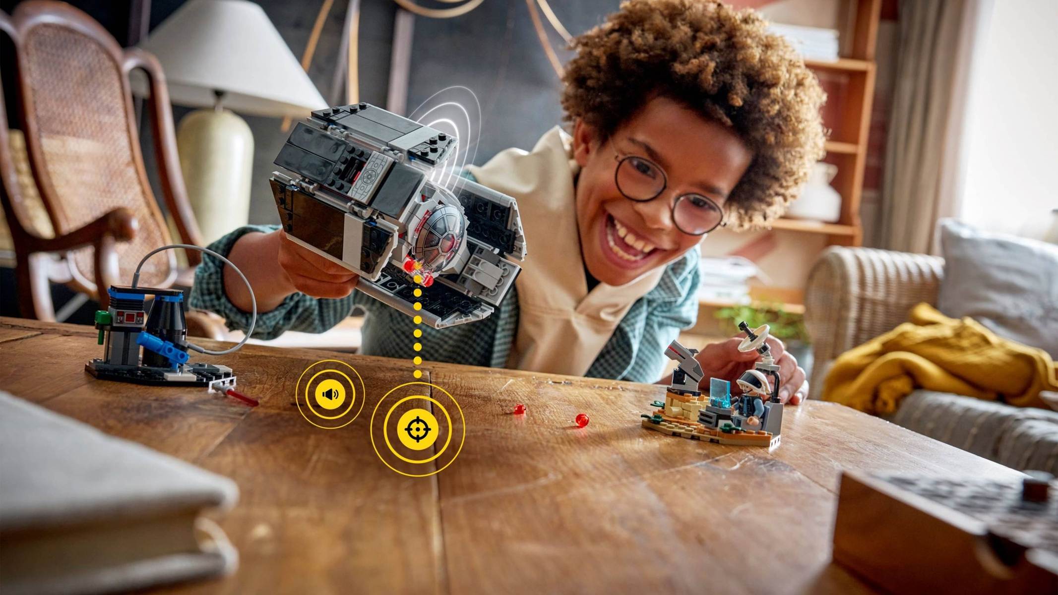 A child playing with a Lego Star Wars Smart Play Darth Vader set. 