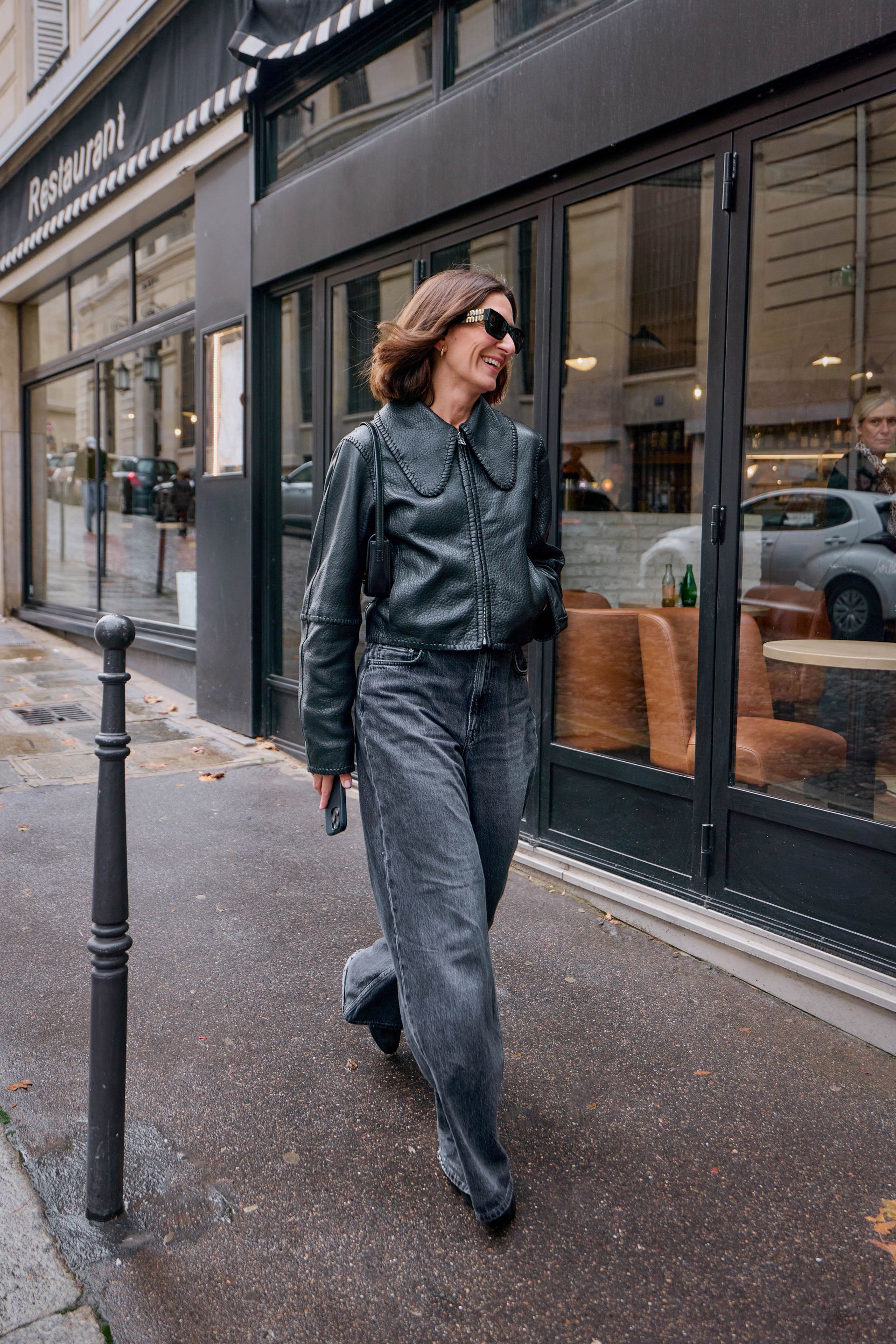 Woman in black jeans, black boots, and black leather jacket.