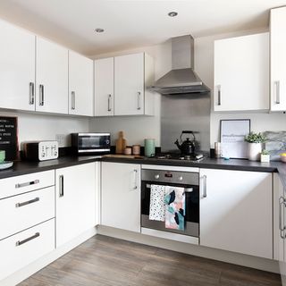 kitchen with white cabinets and chimney