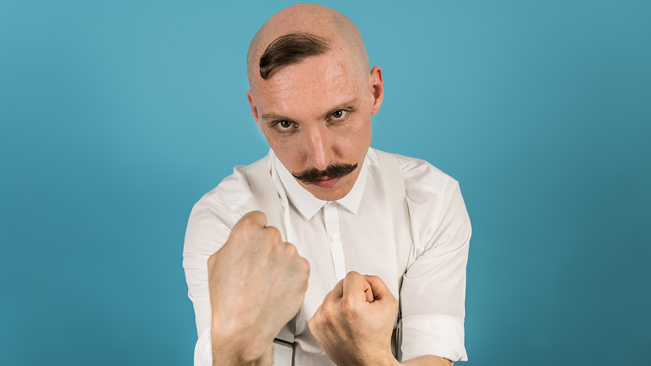 A press shot of Jamie Lenman raising his fists to the screen