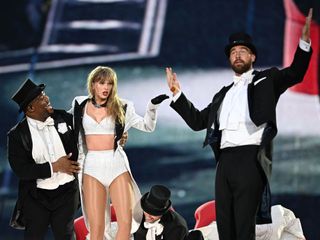 Taylor Swift and Travis Kelce performing on stage during her Eras Tour