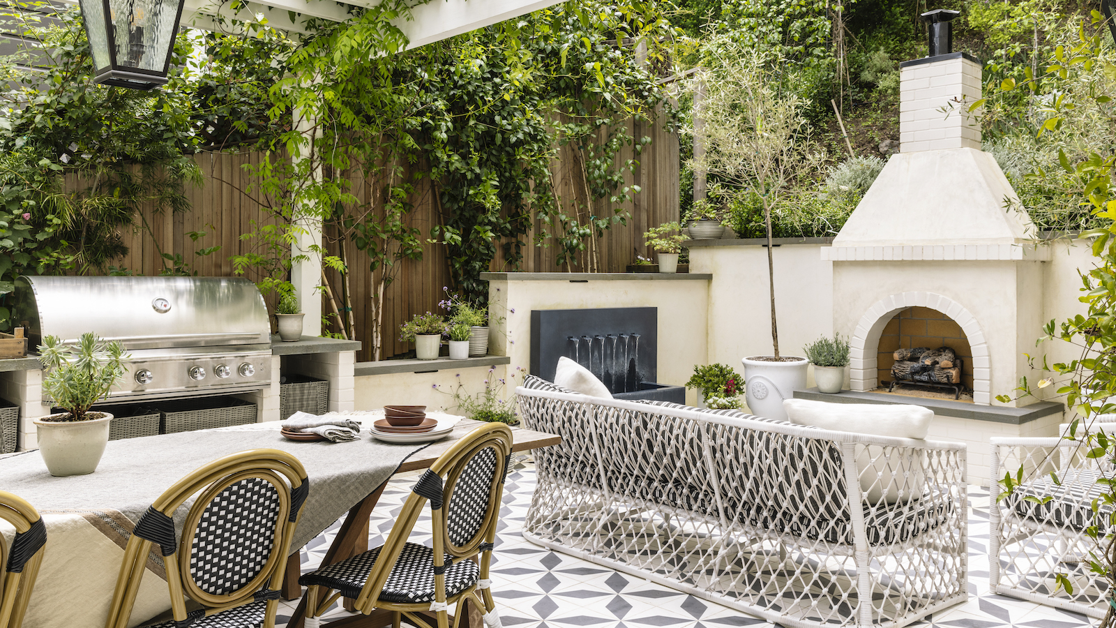 outdoor kitchen with large grill and fireplace