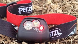 Petzl Actik Core headlamp on bark backdrop