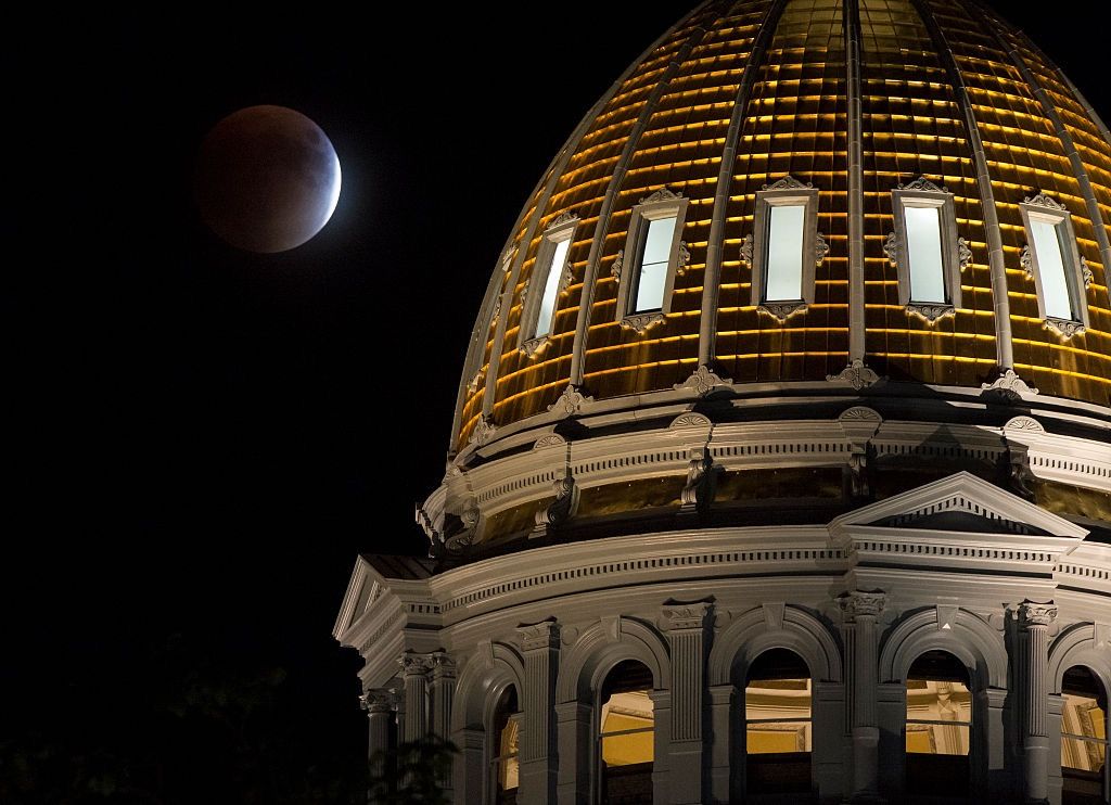 A perigee full moon, or supermoon, is seen during a total lunar eclipse behind The Colorado State Capitol building on September 27, 2015, in Denver, Colorado. 