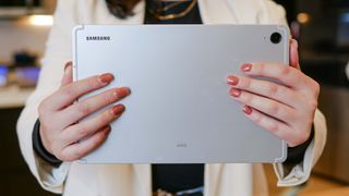 Samsung Galaxy Tab S9 FE held in the hand.
