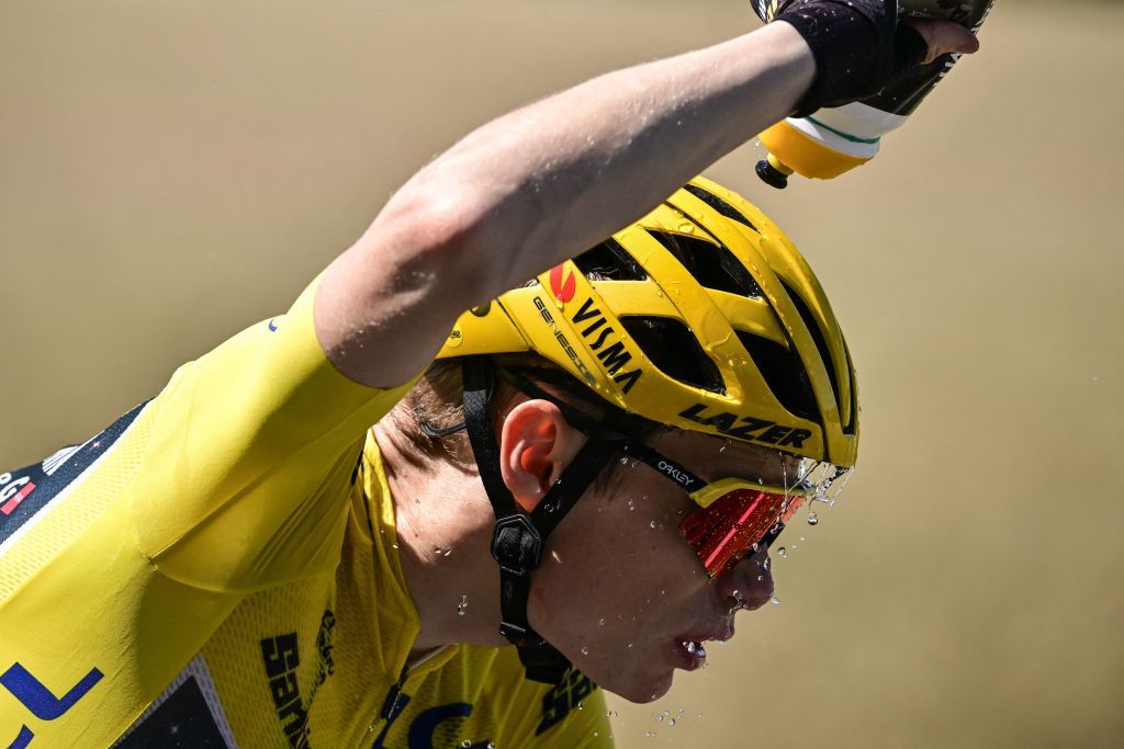 TOPSHOT JumboVismas Danish rider Jonas Vingegaard wearing the overall leaders yellow jersey douses himself with water as he cycles during the 9th stage of the 110th edition of the Tour de France cycling race 1825 km between SaintLeonarddeNoblat and Puy de Dome in central France on July 9 2023 Photo by Marco BERTORELLO AFP Photo by MARCO BERTORELLOAFP via Getty Images