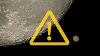 composite image showing in the background a close up view of the moon with jupiter visible close by and in the foreground is a yellow exclamation mark in a triangle.