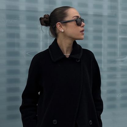 Kira Mackenzie Jackson wearing a black Max Mara coat and pants