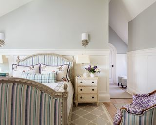 Shabby chic bedroom with striped bed and light walls