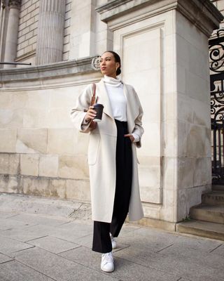 Eva wears her Stan Smiths with tailored trousers, a roll-neck and wool coat