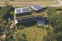 aerial shot of self build with solar panels and green roof
